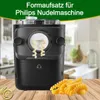 A black pasta maker with fusilli pasta coming out of it, with a pile of fusilli pasta in the foreground and a blurred kitchen background. Podgląd zdjęcia produktu