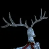 A close-up of a lighted reindeer decoration against a black background. Produktbild-Vorschau
