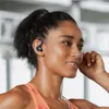 A woman wearing earbuds and exercising. Produktbild-Vorschau