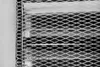 A close-up view of a white metal mesh grill with horizontal slats behind it. Náhľad obrázku produktu