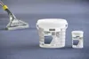 A carpet cleaning machine nozzle and two containers of Kärcher carpet cleaner are placed on a blue carpet. Produktbild-Vorschau