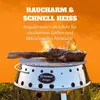 A steak is being grilled on a round, silver grill with flames visible. Produktbild-Vorschau