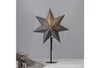 A star-shaped lamp on a stand against a gray wall. Podgląd zdjęcia produktu