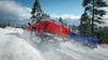 Two pickup trucks driving through snow, one red and one blue, with trees in the background. Produktbild-Vorschau
