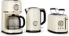 A cream-colored coffee maker, kettle, and toaster set with gold accents are displayed against a white background. Podgląd zdjęcia produktu