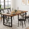 A dining table set up in a room with a window and artwork on the wall. Anteprima dell’immagine prodotto