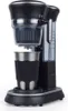A black and silver single-serve coffee maker with a stainless steel travel mug. Produktbild-Vorschau