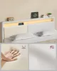 A modern bed frame with LED lighting and a charging station, with close-ups of the material and a hand demonstrating its softness. Náhled obrázku produktu