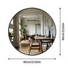 A round mirror reflecting a dining room setting, with size indicators on the side and bottom. Produktbild-Vorschau