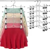 A set of multi-tiered hangers for skirts and pants, with several garments already attached. Produktbild-Vorschau