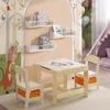 A children's play table and chairs set in a room with a whimsical forest-themed mural and a teepee in the background. Produktbild-Vorschau
