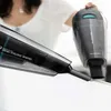 A person is holding two handheld vacuum cleaners, one in the foreground and one in the background. Podgląd zdjęcia produktu