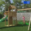 Children playing on a wooden playground set in a backyard. Produktbild-Vorschau