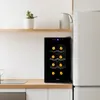 A small wine cooler on a wooden countertop next to a refrigerator. Voir les images du produit