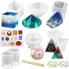 A collection of resin casting molds and finished resin art pieces, along with mixing tools, arranged on a white background. Produktbild-Vorschau