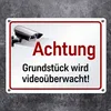 A metal sign with a security camera illustration and German text indicating video surveillance. Produktbild-Vorschau
