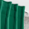 A close-up view of a green curtain hanging from a white curtain rod. Produktbild-Vorschau