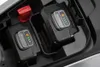 A close-up view of two rechargeable batteries inserted into a charging bay, with a red lever visible. Produktbild-Vorschau