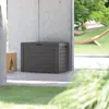 A brown storage box sits on a patio next to a concrete pillar, with a hammock visible in the background. Voir les images du produit