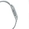 Side view of a silver digital watch with a mesh band. Voir les images du produit