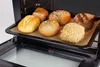 A baking tray with six different types of bread rolls inside an oven. Náhled obrázku produktu