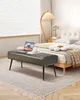 A bedroom scene with a bed, a bench, a lamp, and a window. Anteprima dell’immagine prodotto
