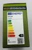 The image shows the packaging of a MILOS LED-Einbauleuchte with an energy efficiency label. Produktbild-Vorschau