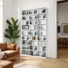 A tall white bookshelf filled with CDs and DVDs, placed next to a large green potted plant and a brown couch in a living room. Produktbild-Vorschau