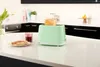 A mint green toaster with toast and jam on a kitchen counter. Podgląd zdjęcia produktu