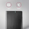 A close-up of a black external hard drive with brushed metal texture, featuring two circular icons with text above it. Produktbild-Vorschau