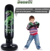 A child wearing boxing gloves stands next to an inflatable dinosaur punching bag. Produktbild-Vorschau