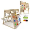 A child playing on a wooden climbing frame with a slide, climbing wall, and rings. A smaller image of the climbing frame is shown in the background, along with a product tag. Podgląd zdjęcia produktu