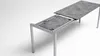 A table with a stone-like surface, partially extended, on a white background. Produktbild-Vorschau
