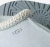 Close-up of the top edge and side of a light blue UGG slipper. Produktbild-Vorschau
