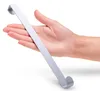 A hand is holding a silver hook on a white background. Produktbild-Vorschau