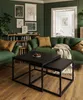 A living room scene with a green sofa, coffee table, and artwork on the wall. Produktbild-Vorschau