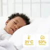 A baby sleeping on a pillow with temperature and humidity readings displayed. Podgląd zdjęcia produktu