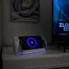 A PlayStation Portal charging dock is placed on a dresser next to a TV. Anteprima dell’immagine prodotto