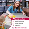 A woman is cleaning a table with a yellow cloth, while a child is sitting at the table with food. Produktbild-Vorschau