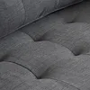 A close-up view of the tufted fabric of a gray sofa. Produktbild-Vorschau
