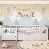 A white wooden children's bed with a mountain-themed mural on the wall behind it. Anteprima dell’immagine prodotto