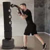A man is boxing with a free-standing punching bag in a gym-like setting. Produktbild-Vorschau