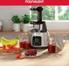A kitchen counter scene with a juicer, fruits, and a slice of cake. Náhled obrázku produktu