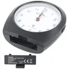 A black alarm clock with a white face is shown, with its battery compartment and a separate battery cover in the foreground. Náhľad obrázku produktu