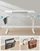 A collage showing parts of an adjustable standing desk with accessories. The main image shows the frame and desktop separately, while the smaller images showcase hanging storage and a headphone/bag hook. Produktbild-Vorschau