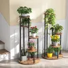 Two multi-tiered plant stands are displayed indoors, filled with various potted plants. Podgląd zdjęcia produktu