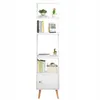 A white bookshelf with wooden legs, decorated with books and plants. Produktbild-Vorschau