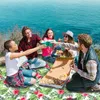 A group of friends having a picnic on a cliff overlooking the ocean, with pizza and drinks. Náhled obrázku produktu