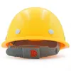 A yellow hard hat with a gray adjustable strap and a red button. Produktbild-Vorschau
