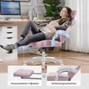 A woman relaxing in a pink gaming chair with her feet up on a footrest, in a home office setting. Náhled obrázku produktu